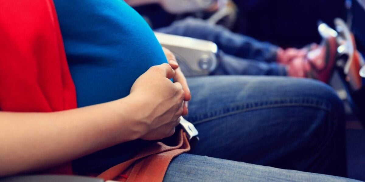 pregnancy-woman a pregnant woman sitting in a char thinking about the importance of health insurance reviews when having a baby abroad