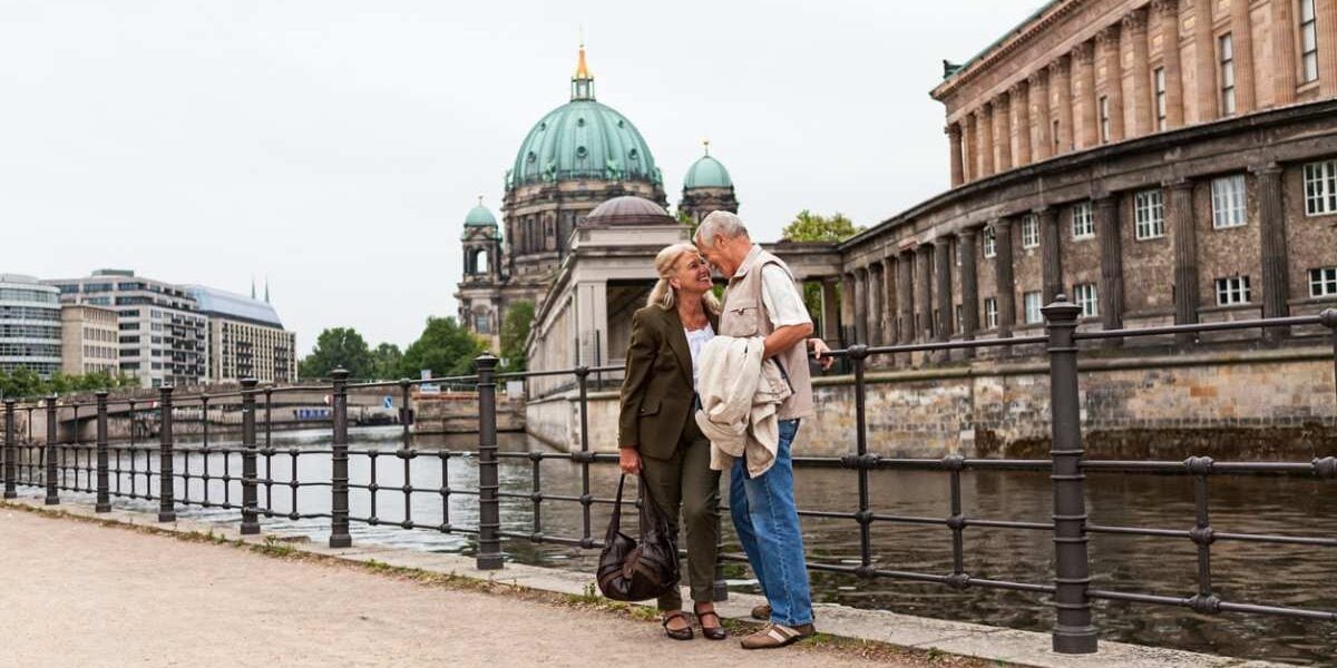 senior-couple-berlin a senior couple standing in front of Berlin Cathedral, having bought travel insurance for Germany