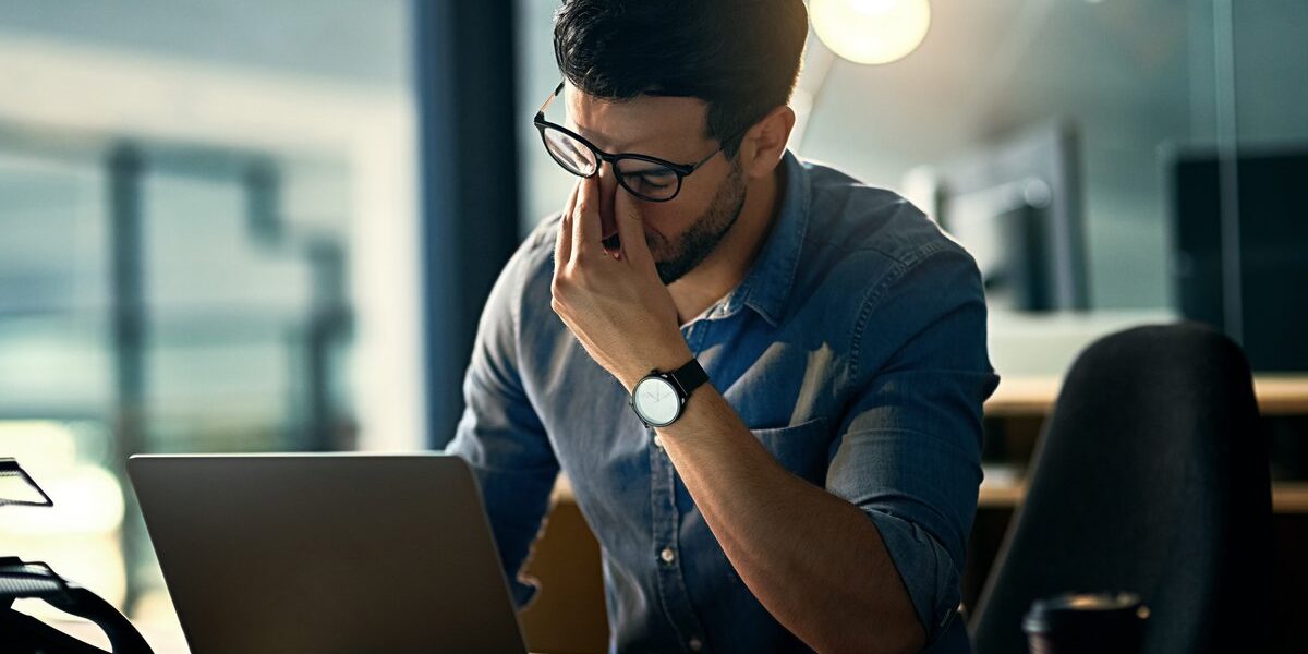 stressed-businessman a stressed man sitting at a work desk in the US, which is not one of the healthiest countries in the world