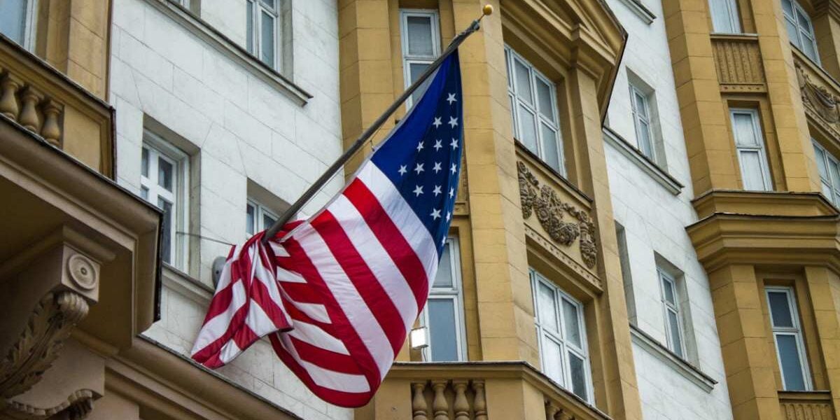 us-embassy-moscow-russia The American flag flapping in the wind outside the US embassy in Moscow, Russia