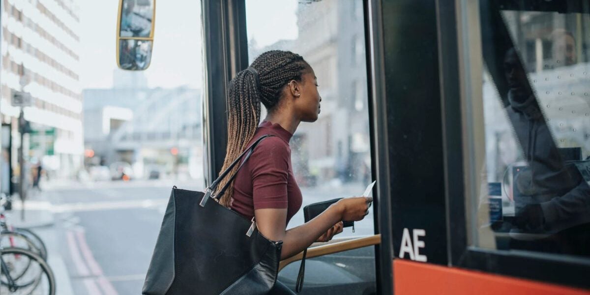 woman-boarding-bus a woman boarding a bus in a new city, after becoming an expat