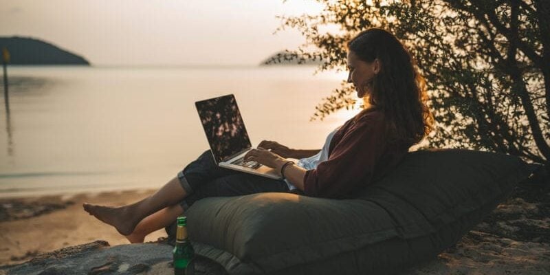 digital nomad working on the beach